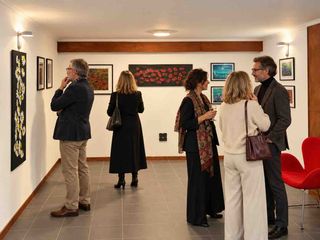 Visitors viewing and discussing artworks at Dizaura Gallery in Waterloo