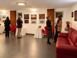Dizaura Gallery exhibition space with visitors, artworks and seating